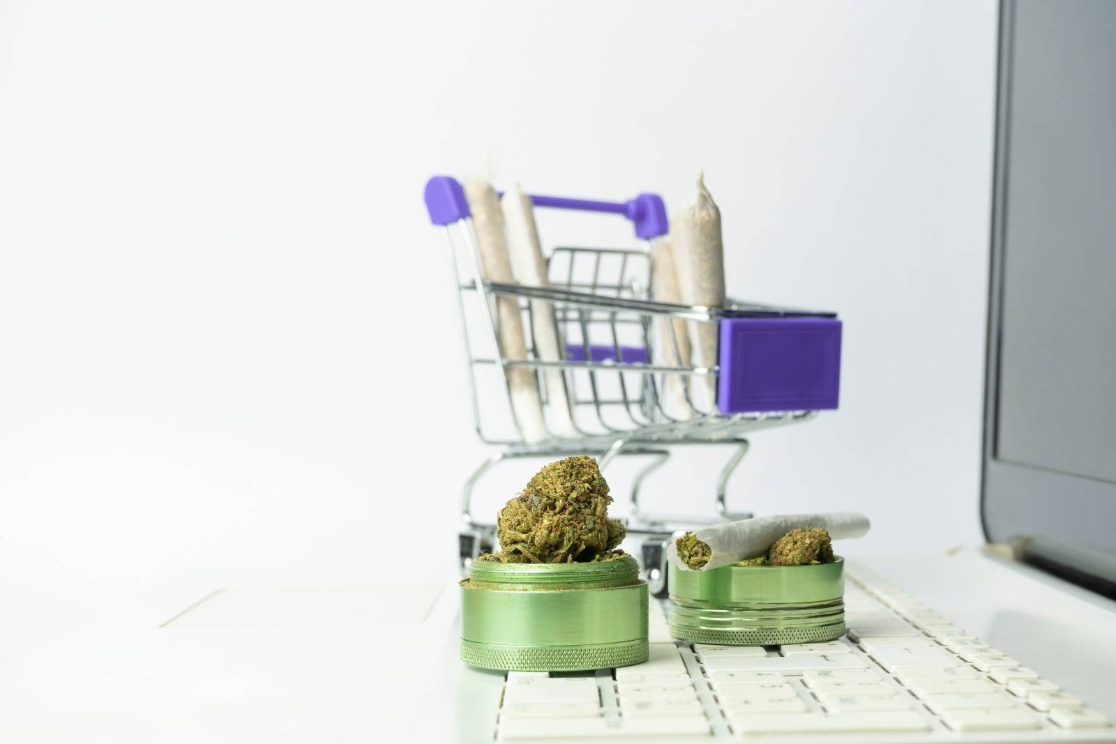 Grinder with marijuana buds and joints in shopping cart ordering from a Manitoba dispensary. Speed Greens