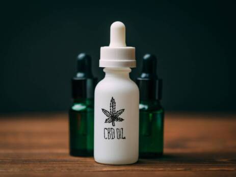 White glass bottle and two green bottles with text CBD Oil. Speed Greens