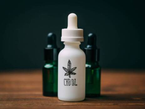 White glass bottle and two green bottles with text CBD Oil. Speed Greens