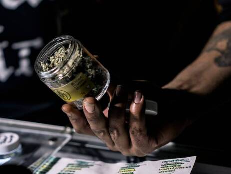 Vendor Showing Off A Jar Of Cannabis Flowers for BC dispensary. Speed Greens