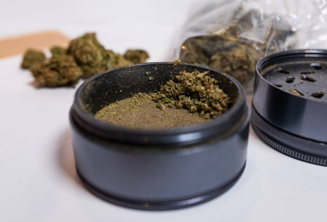 Ground up cannabis in weed grinder. Speed Greens
